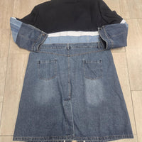 Tailored Black Top: The upper portion resembles a structured blazer, complete with a button closure, giving this coat an elegant edge.
Denim Bottom Half: The lower section boasts a classic denim look, with a mid-length skirt, slight fraying at the hemline, and patch pockets on the back.
Statement Stripe: A white and pale blue stripe runs horizontally across the chest and arms, tying together the top and bottom halves.
Longline Silhouette: The long length adds a trench coat vibe,