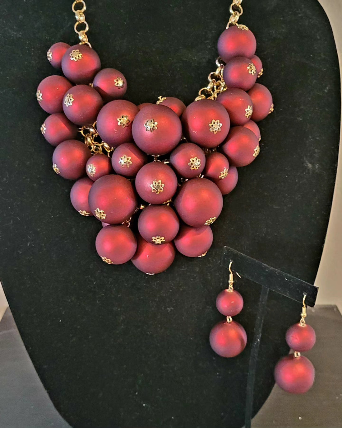 gold tone statement necklace with linked chain, red multi size balls as focal point and matching earrings