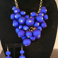 gold tone linked necklace and matching earrings,  Blue multi ball pendant as the focal point