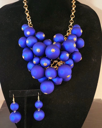 gold tone linked necklace and matching earrings,  Blue multi ball pendant as the focal point